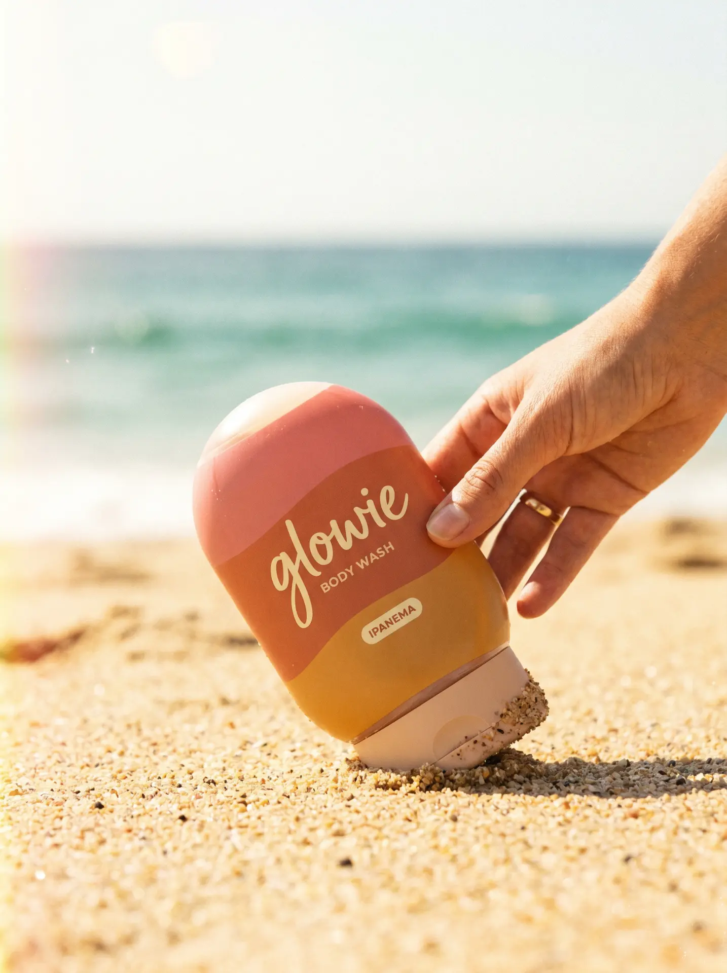 Glowie bottle on sand, campaign creative concept
